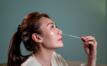 photo of women using nasal swab