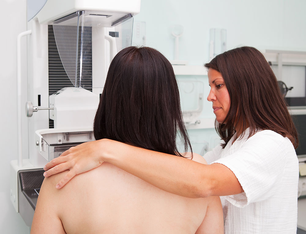 nurse with young woman having a mammogram