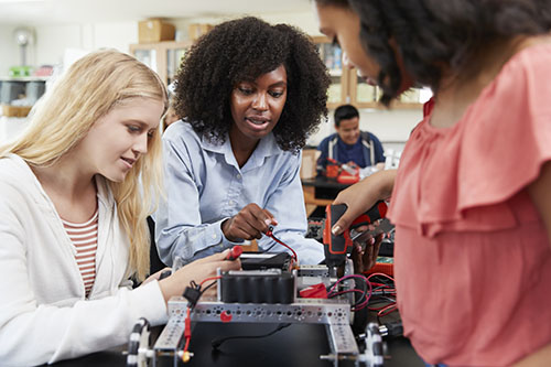 women students working with robotics