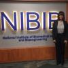 Carla Pugh posing in front of NIBIB sign