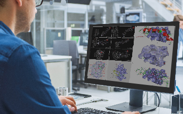 man looking at data models on computer screen