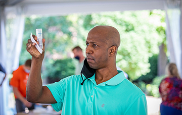 man holding vial with test sample