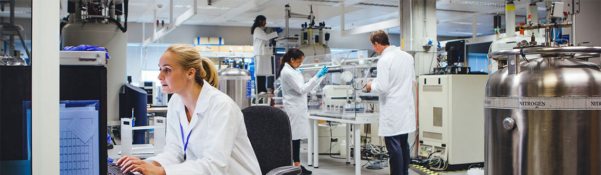 woman in lab typing on keyboard