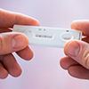 hands holding COVID test