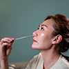 side view of woman using nasal swab