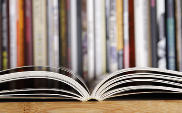 picture of open book and books on a shelf