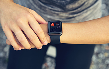 person checking smart device worn on the wrist