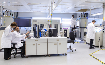 Pictures of people in lab coats working in a science lab