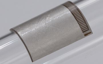 A flexible, wearable ultrasound patch, bent around a tube