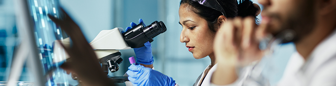 Woman looking into a microscope