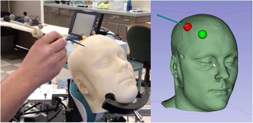 The image shows a hand holding a long thin device against a white mannequin head as well as a computer rendering of the head with the digital trackers.