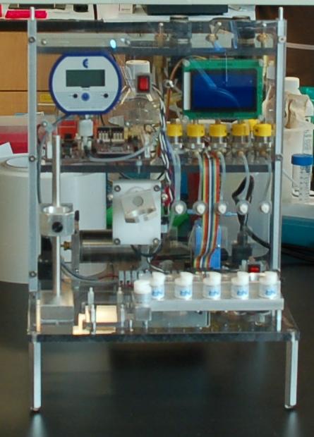 Image of a fully automated bench top CTC processing machine. Una mesa de trabajo completamente automatizada para procesamiento CTC, que conecta al CTC-chip con una bomba neumática que empuja la sangre a través del aparato.