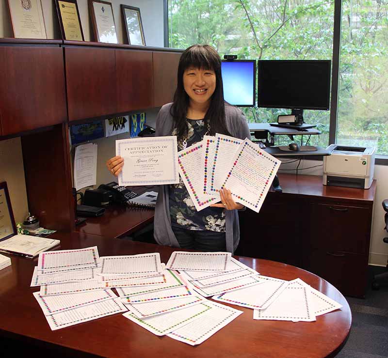 Grace Peng displays Certificate of Appreciation and thank you letters from students at Fulton Elementary School, Fulton, Maryland.