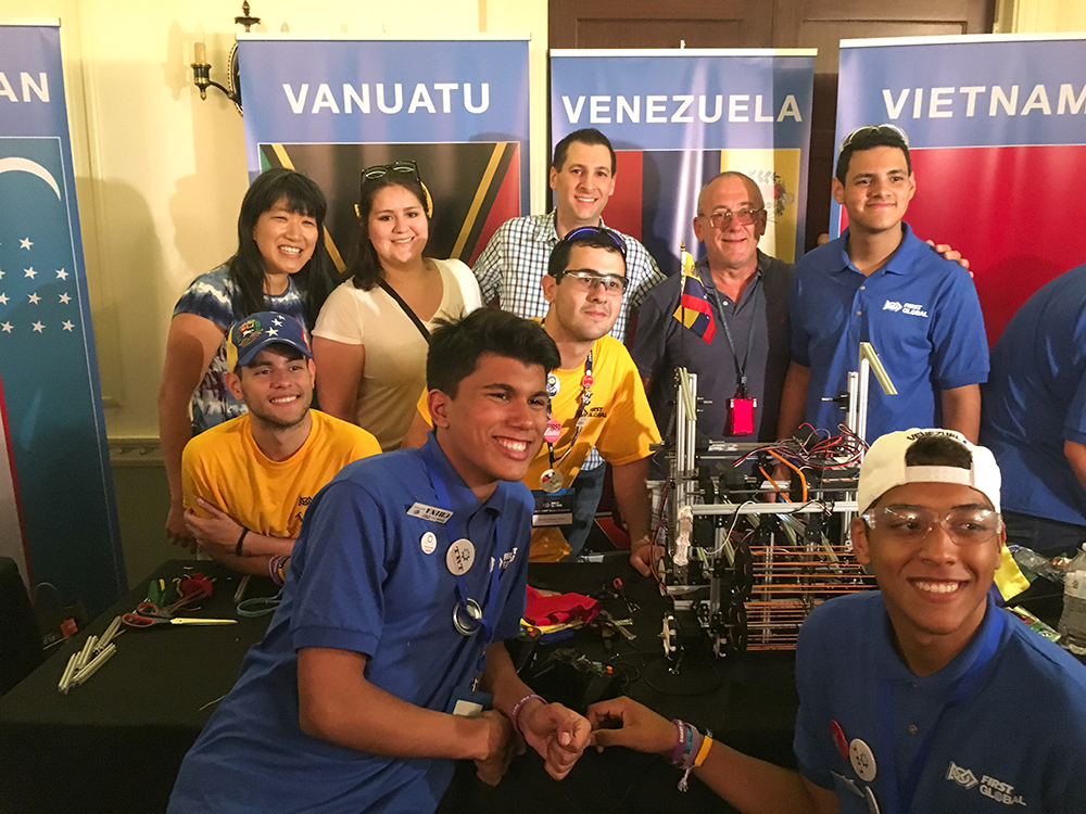 Team NIBIB’s first in-person meeting with Venebot team members on the evening before the competition. Back row, from left, NIBIB’s Grace Peng, Emily Conlan, Andrew Weitz and Steve Zullo. Wearing yellow t-shirts, from left, Venebot college student team leaders Javier Carroz and Kenny Urdaneta. In blue, high school Venebot team members Emanuel Andrade, Freddy Sarcos, foreground, and Samuel Larreal, at right alongside NIBIB advisors. Photo by Mehran Armand for NIBIB.