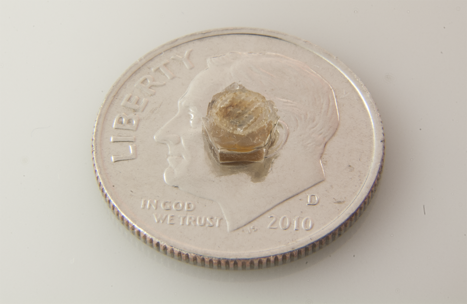 Photo of interstitial pressure sensor on top of a dime for scale.