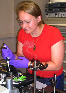 This is a photo of a student pipetting in a research lab