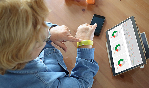 woman looking at her wearable device