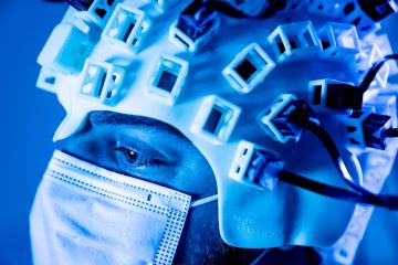 Man wearing brain scan helmet with sensors