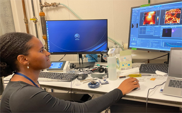 Adia Drayton views an atomic force microscopy image on a computer monitor.