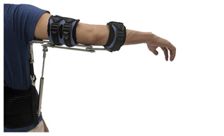 A man’s arm is being held straight out to his right by metal connected to straps on his arm and a waist band.