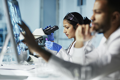 Two scientists from underrepresented populations working in a lab