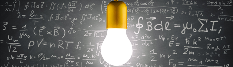 A lit up lightbulb in front of a chalkboard with many equations written on it