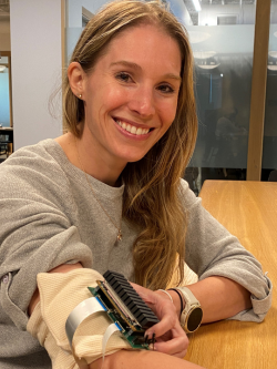 Woman wearing a prototype of her device