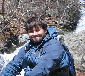 George Patterson sitting outside by a river