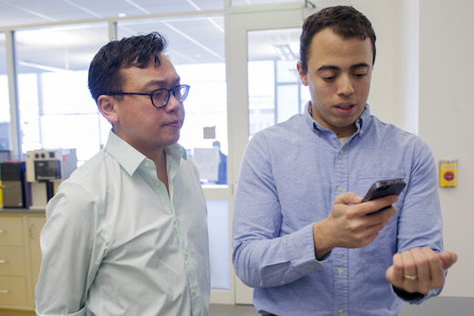 two researchers using smartphone