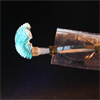 A photo of a surgical robotic catheter, placed within a plastic tube. A stabilizing mechanism is deployed within the tube while the flexible tip outside of the tube is bent.