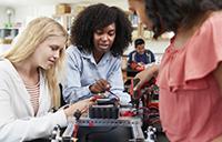 three female students training in a lab