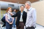 NIBIB Staff Scientist Albert Jin discuss a research poster with conference attendees.