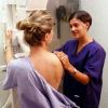 patient and technician at mammography machine