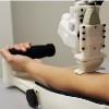 robot drawing blood from patient arm